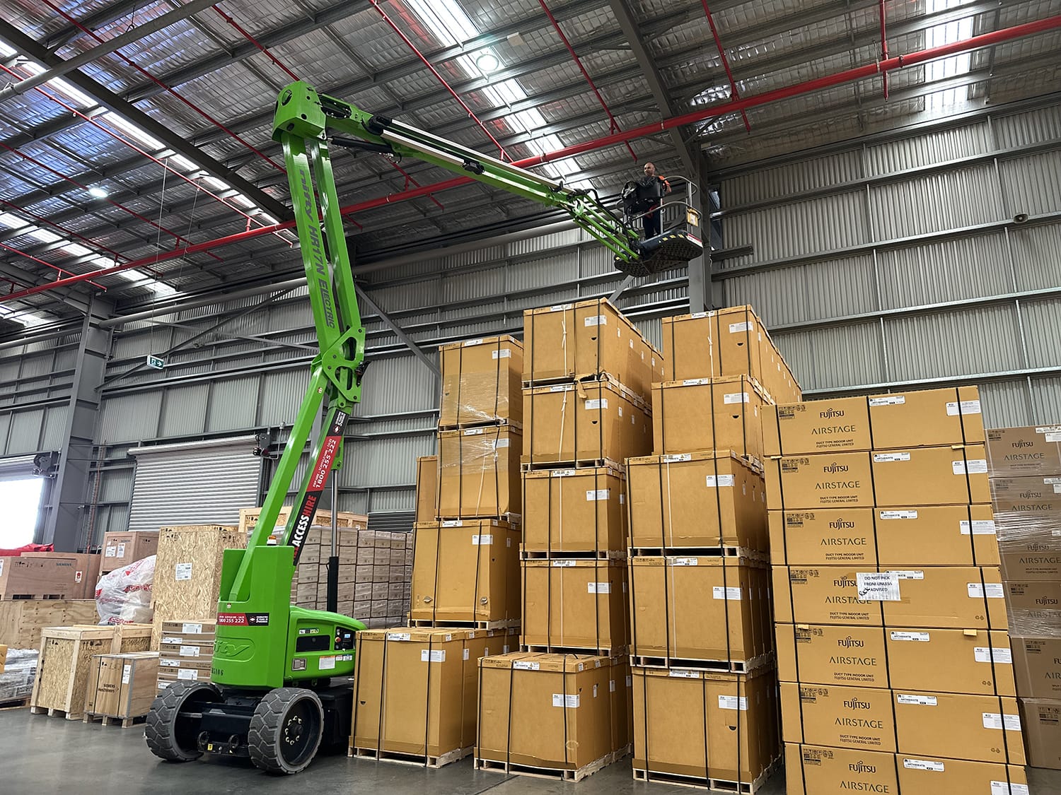 Warehouse worker on a Knuckle Boom Lift