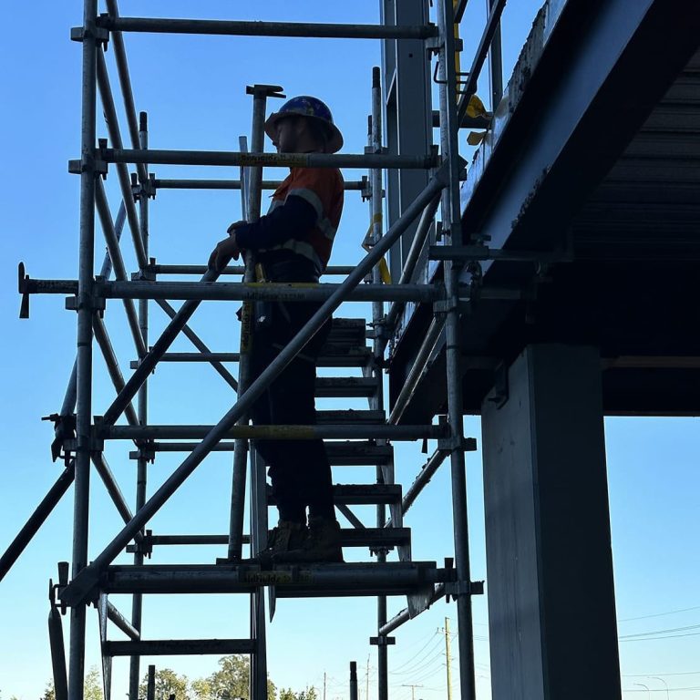 Worker standing on scaffold