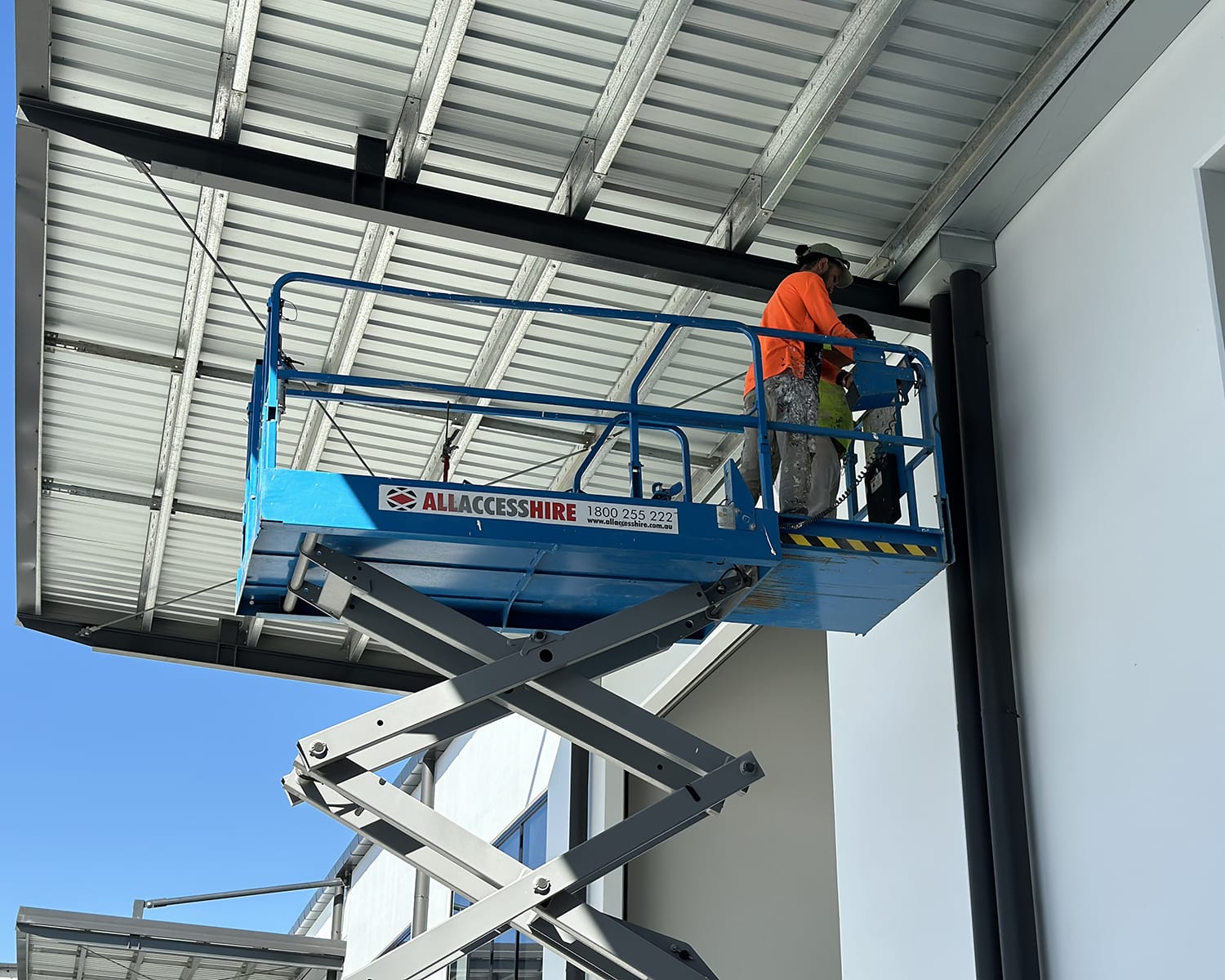 Construction worker on an All Access Hire Scissor Lift