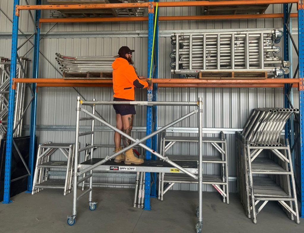 Scaffolder with orange shirt installing All Access Scaffold Hire Scaffolding Brisbane.