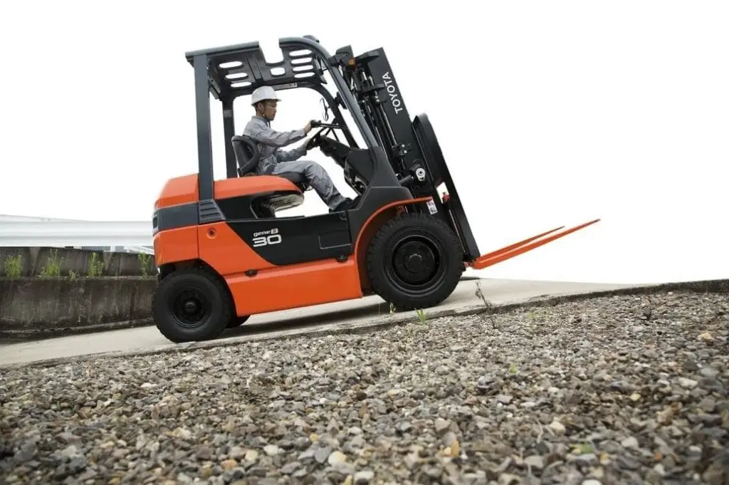 Toyota 3T electric forklift in operation with driver onboard, built for heavy-duty indoor and outdoor lifting tasks