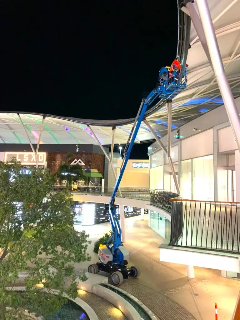 Elevated night work using Genie Z-60 FE boom lift from All Access Hire, providing safe access for technicians working at height.