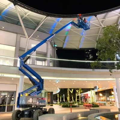 boom-lift-hire-genie-all-access-hire (2) Hybrid boom lift for nighttime urban works operating at Pacific Fair Shopping Centre, Gold Coast – quiet and efficient elevated access solution.